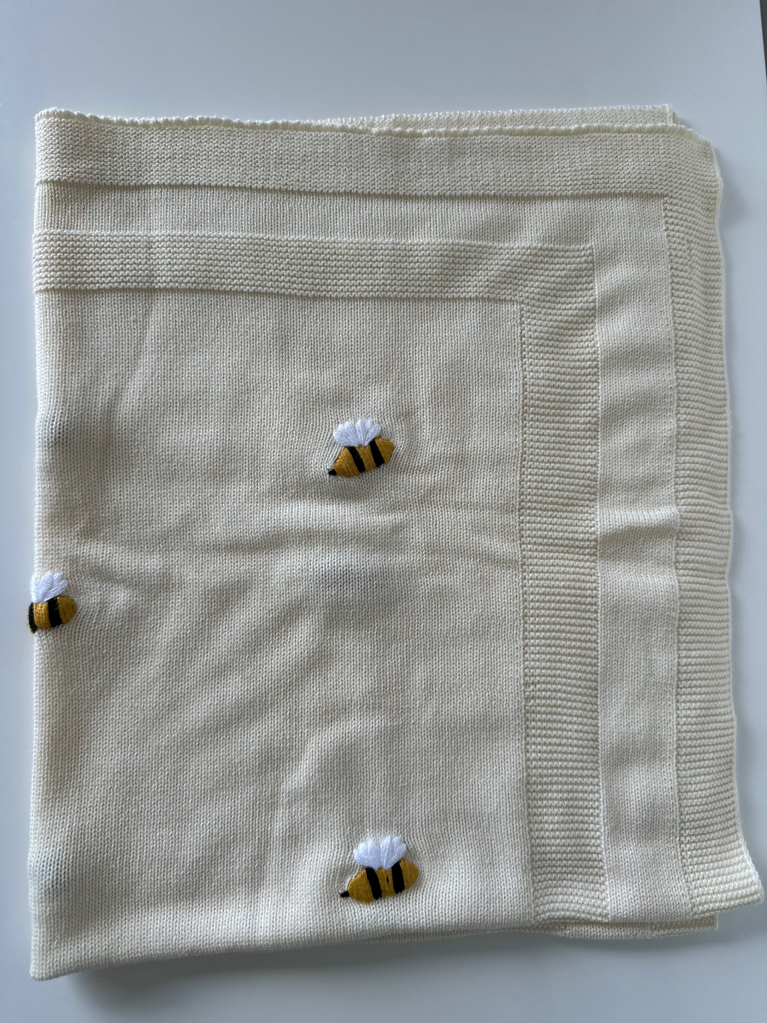 cream knit baby blanket with bee design