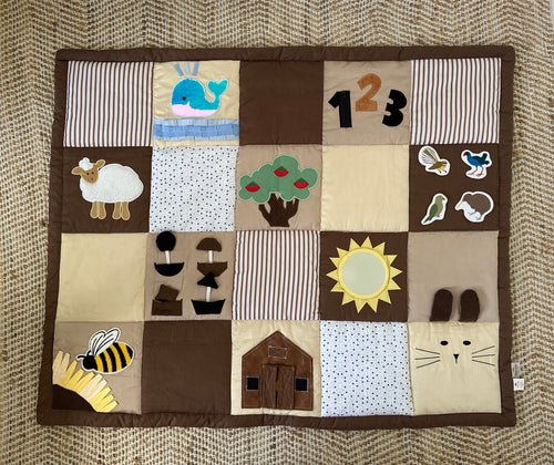 Baby sensory play mat with different textures and animal illustrations