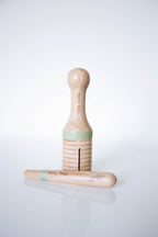 Wooden ribbed tube with stick on a white background