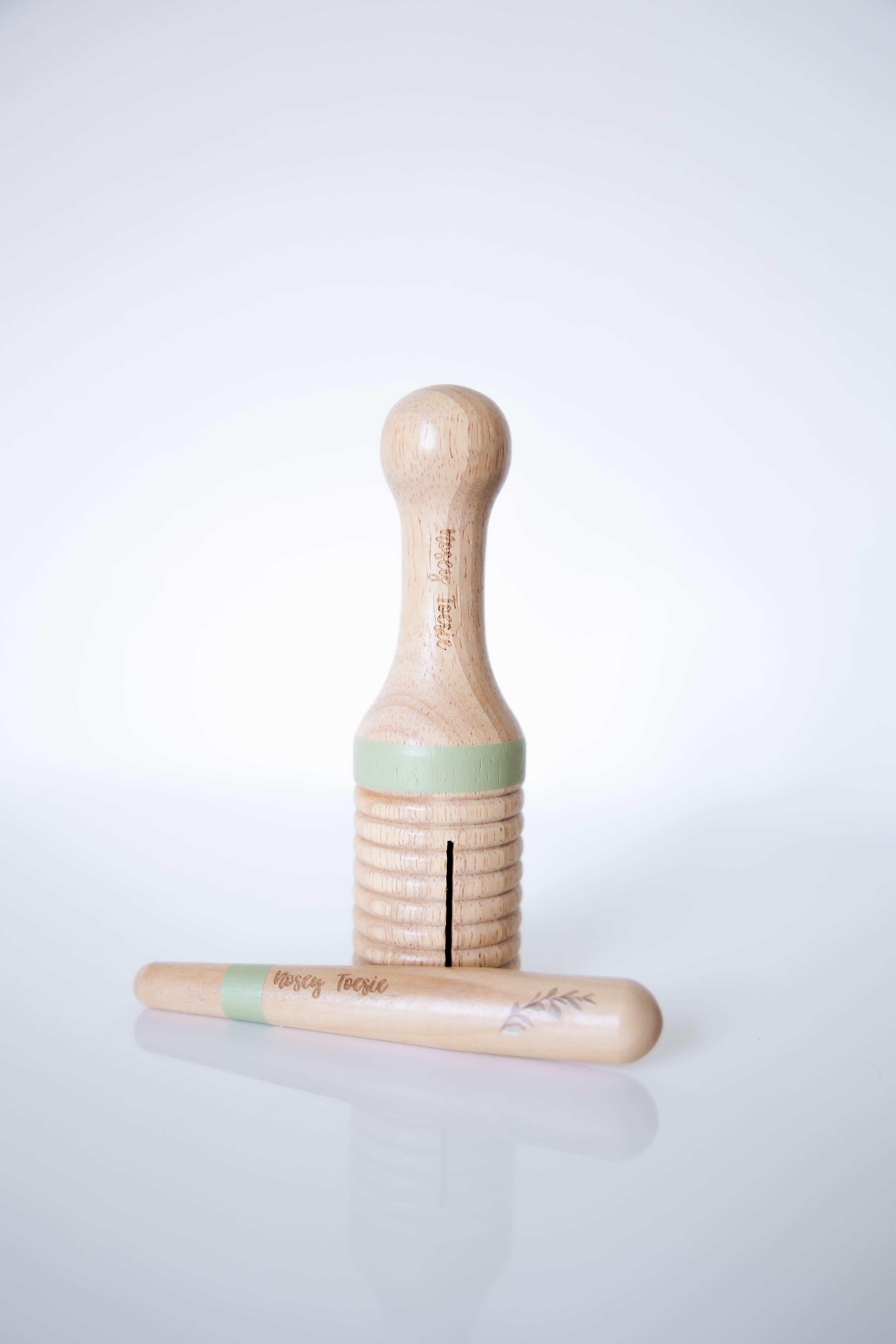 Wooden ribbed tube with stick on a white background
