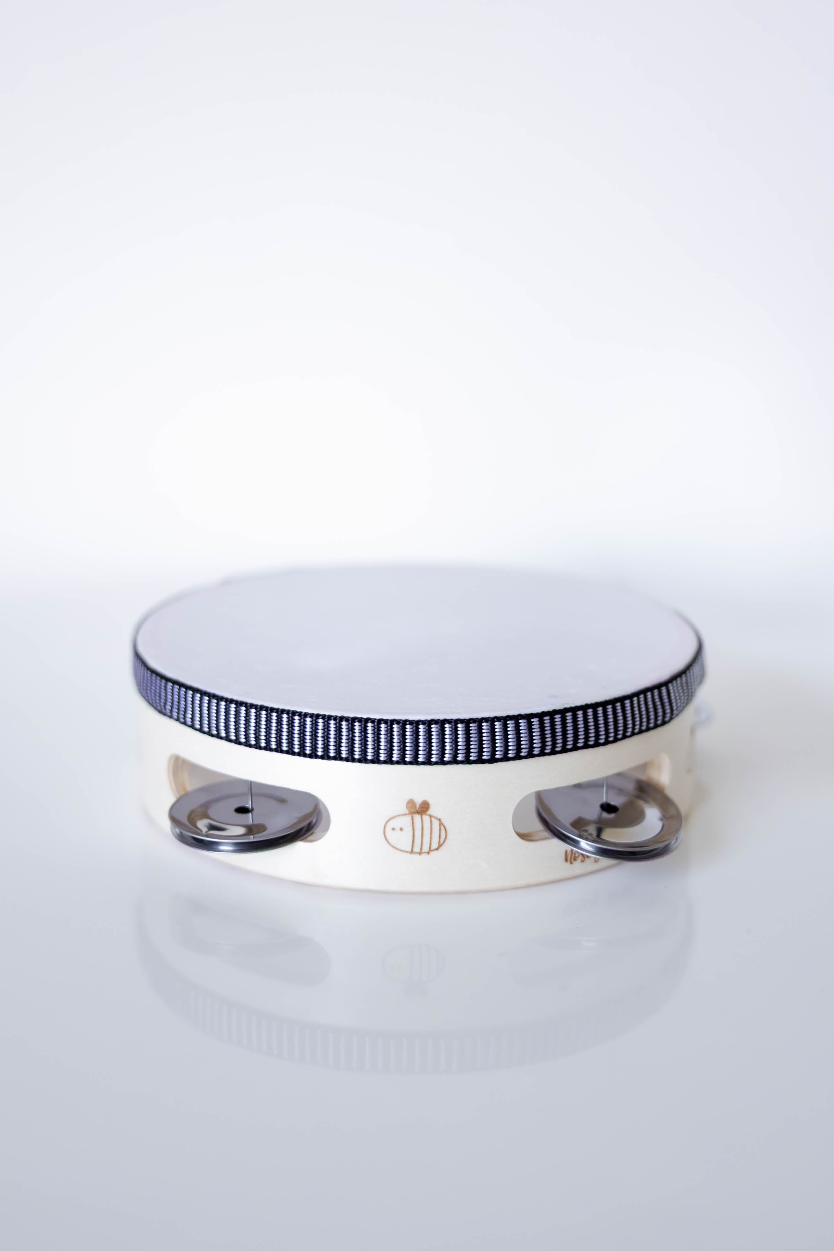 White and wooden tambourine with black rim on a white background