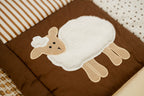 Children's play mat with a sheep design on a brown background